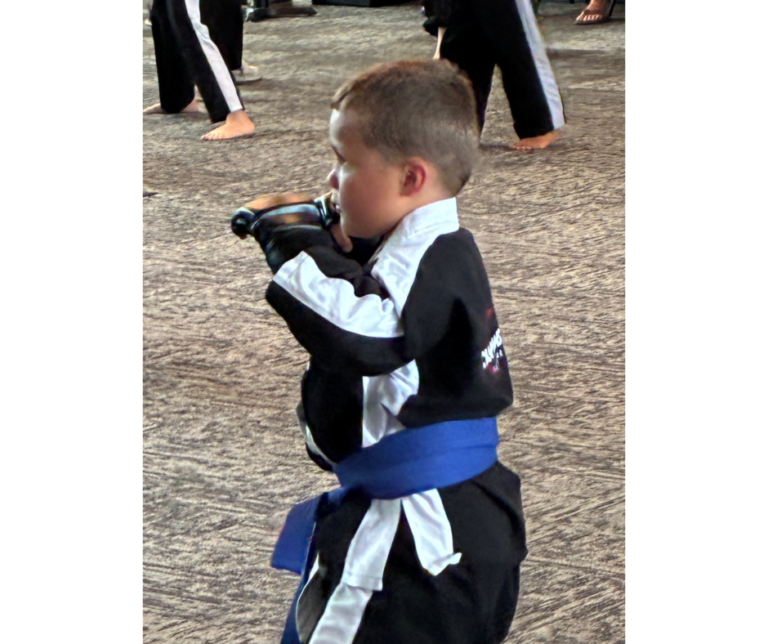 child practicing martial arts training to build confidence and reduce anxiety in kids